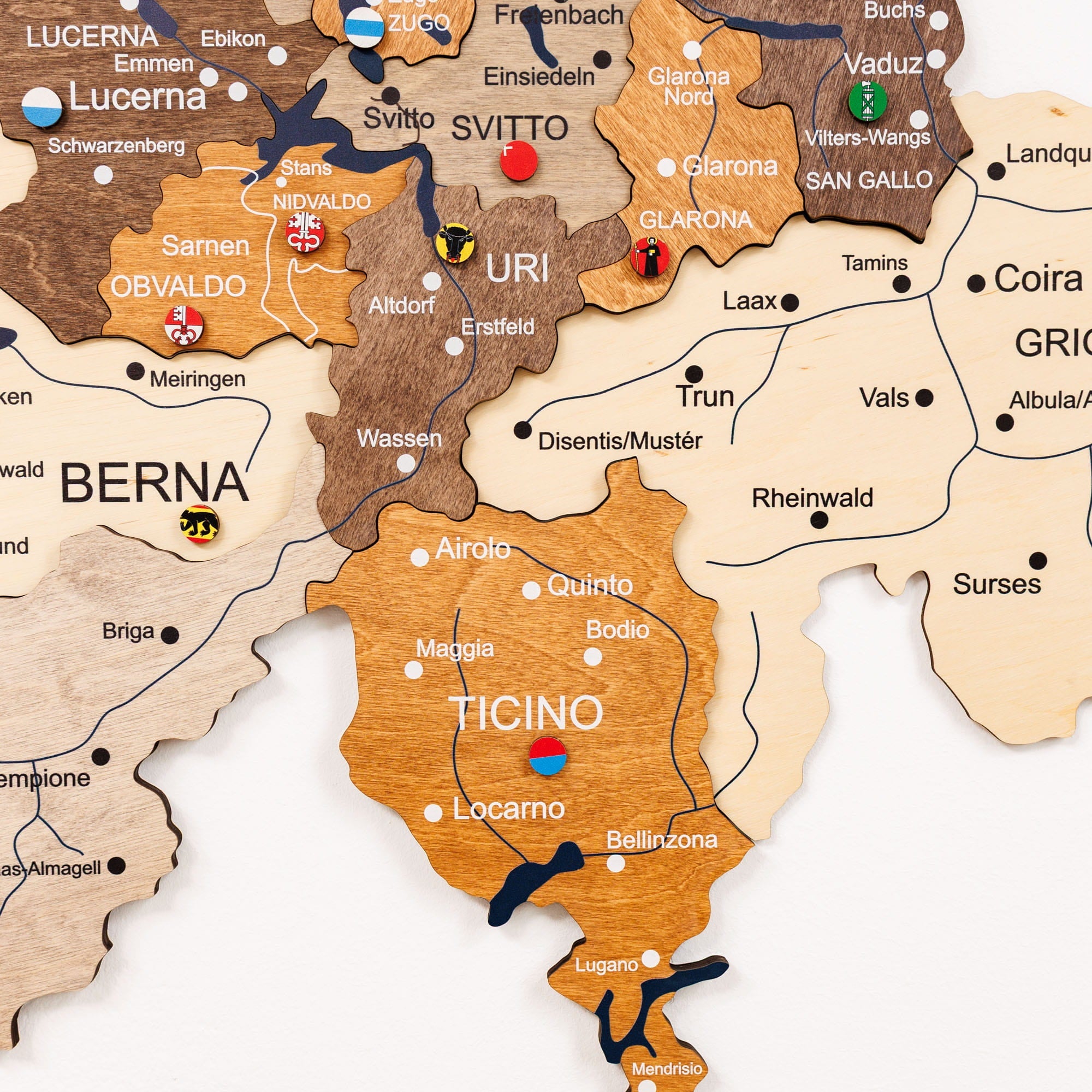 Wooden map of Switzerland with cantonal borders and names.